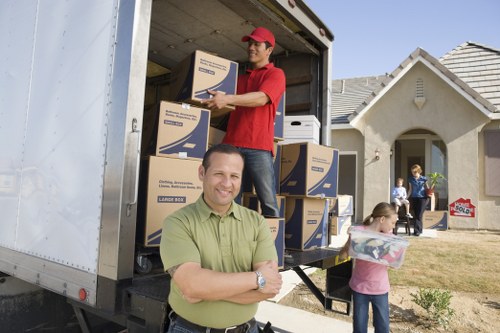 Movers carrying items through a Hammersmith apartment building