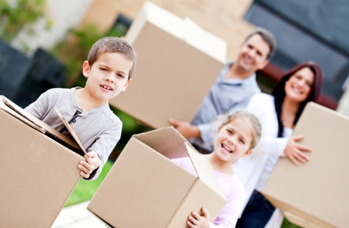 Flat move with furniture being carried from a West London apartment building