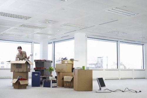 Staff organizing desks and equipment during a Hammersmith office move